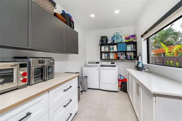 a kitchen with counter top space stove and cabinets