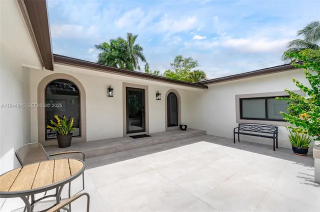 a view of a house with swimming pool and sitting area
