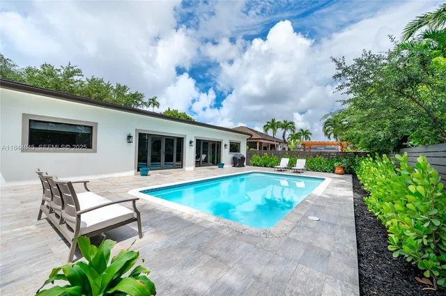 a view of a backyard with swimming pool