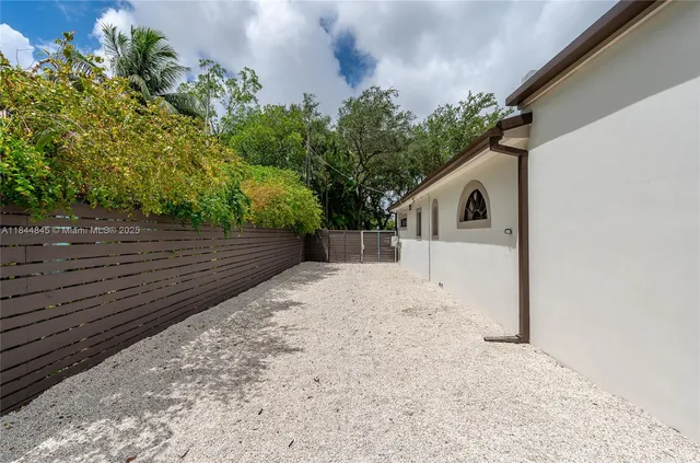 a backyard of a house with lots of green space and fountain