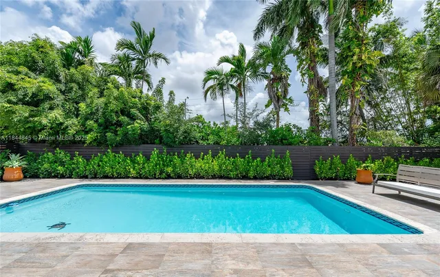 an aerial view of a house with a yard basket ball court and outdoor seating