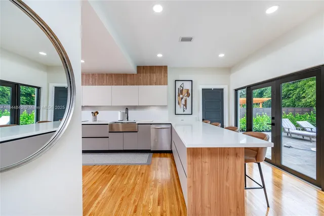 a living room with large window and wooden floor