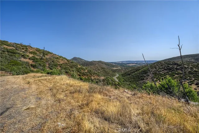 a view of a large building with mountains in the background