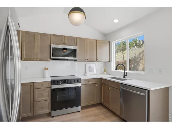 a kitchen with a sink stove and microwave