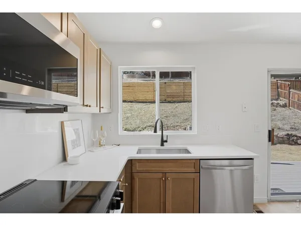 a kitchen with a sink cabinets and a window
