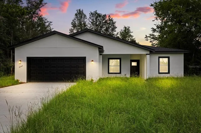 a front view of house with yard and green space