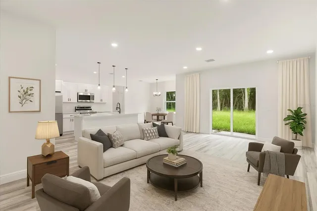 a view of an empty room with kitchen and a window