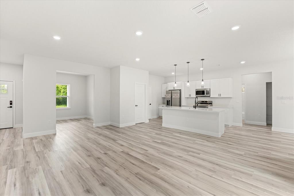 2097 Southwest 153rd Loop Ocala, FL 34481 - Photo 16 of 39 a view of kitchen with kitchen island wooden floors appliances and cabinets