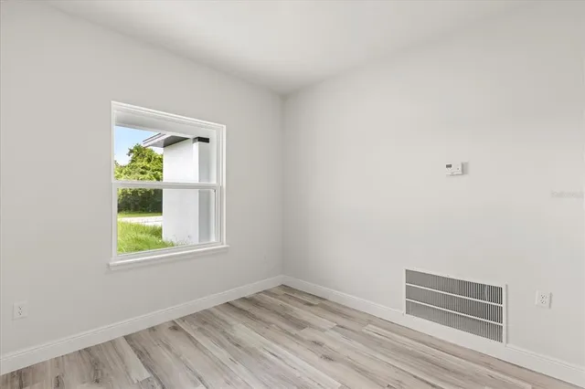 a view of an empty room and wooden floor