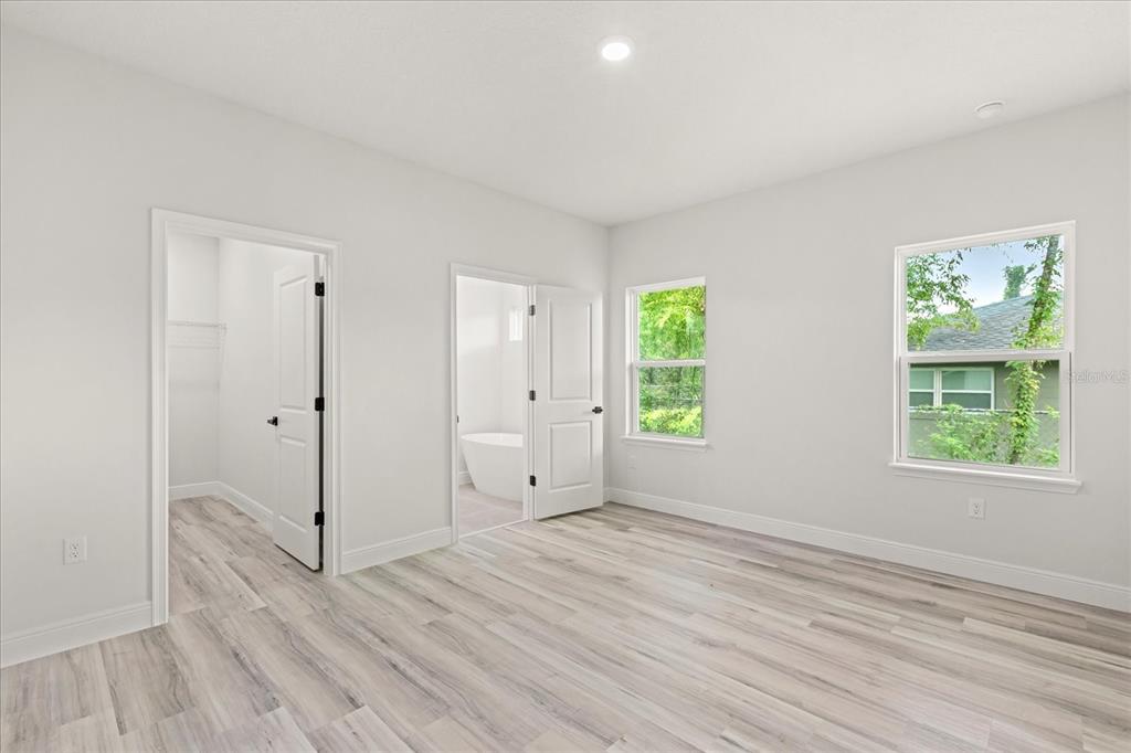 2097 Southwest 153rd Loop Ocala, FL 34481 - Photo 27 of 39 a view of empty room with wooden floor and fan