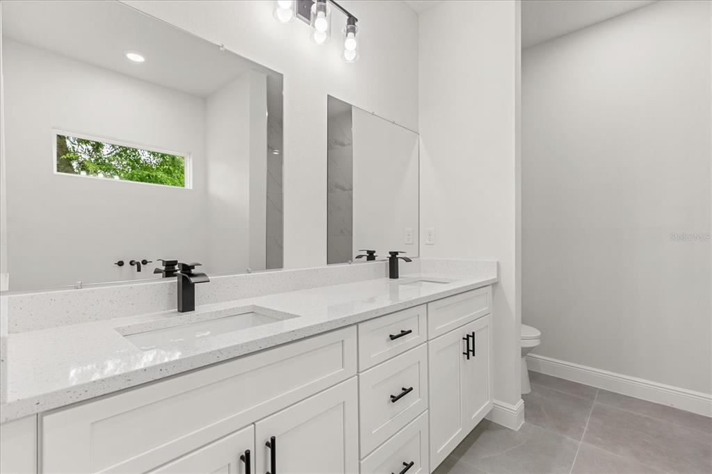 2097 Southwest 153rd Loop Ocala, FL 34481 - Photo 28 of 39 a bathroom with a double vanity sink and mirror