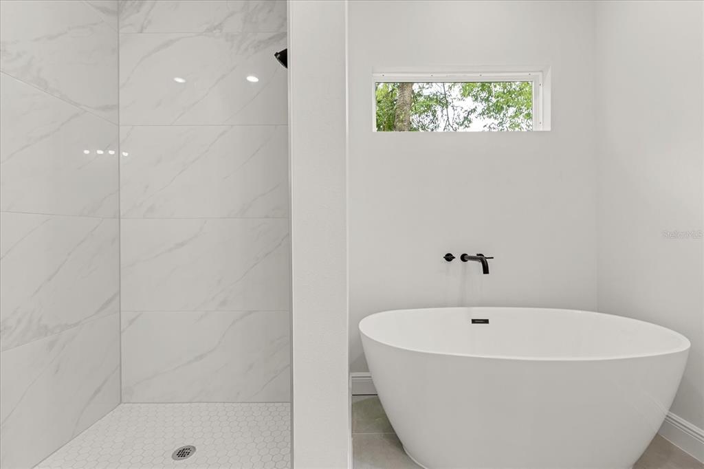 2097 Southwest 153rd Loop Ocala, FL 34481 - Photo 29 of 39 a white bath tub sitting in a bathroom