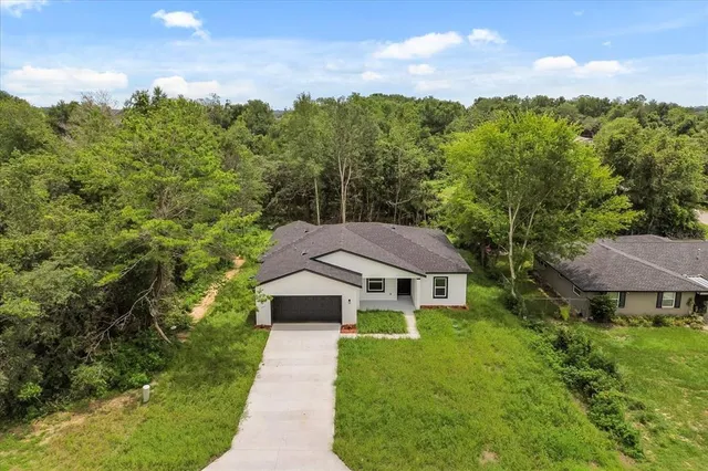 a aerial view of a house with a yard