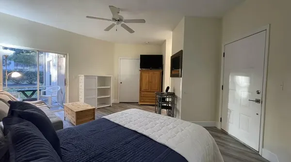 a bedroom with a bed dresser and a large mirror