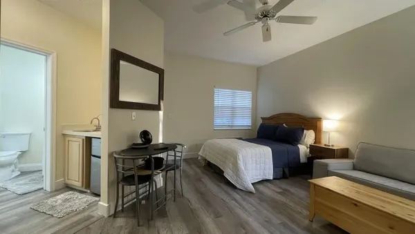 a bedroom with bed and a window