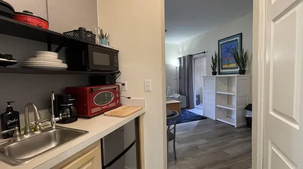 a kitchen with a refrigerator and a sink