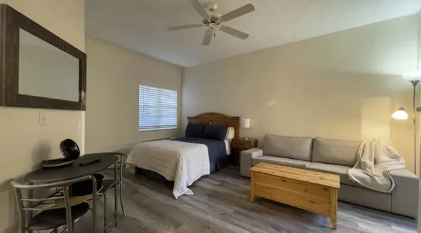 a bedroom with a bed and a couch