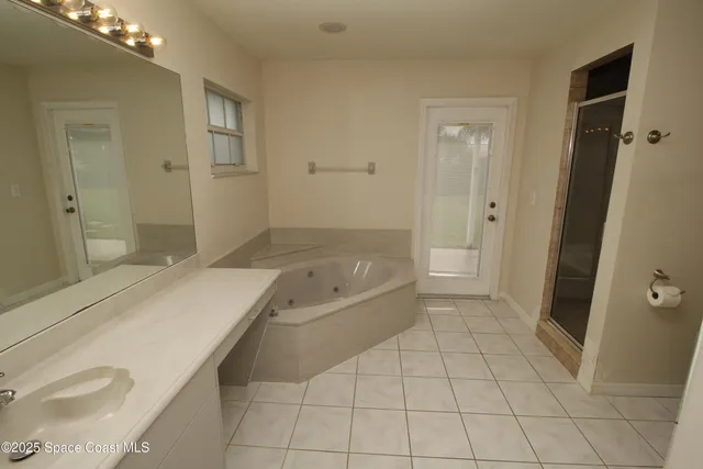 a spacious bathroom with a granite countertop sink a toilet and shower