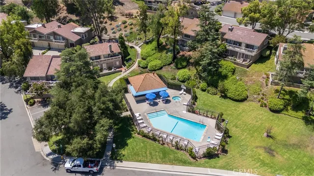 an aerial view of house with yard swimming pool and outdoor seating