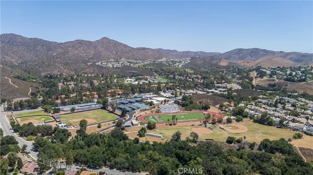 an aerial view of residential house and sandy dunes