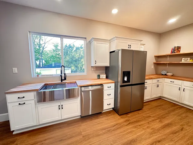 a kitchen with a refrigerator and a sink