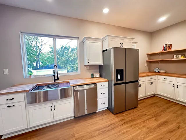 a kitchen with white cabinets and white appliances
