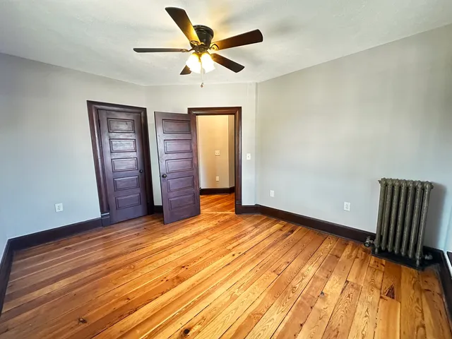 wooden floor in an empty room with a window