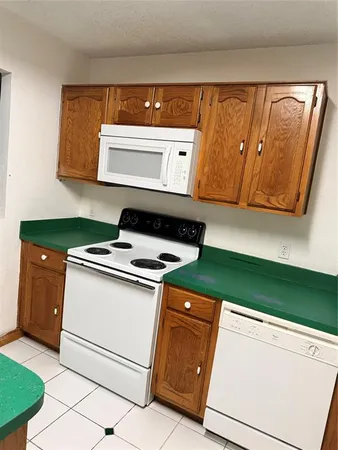 a kitchen with granite countertop cabinets and a stove top oven