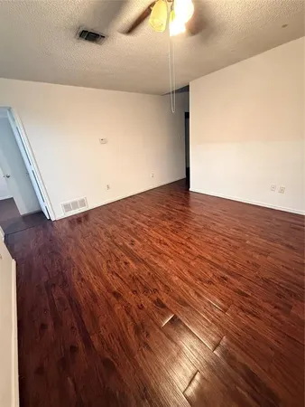 an empty room with wooden floor