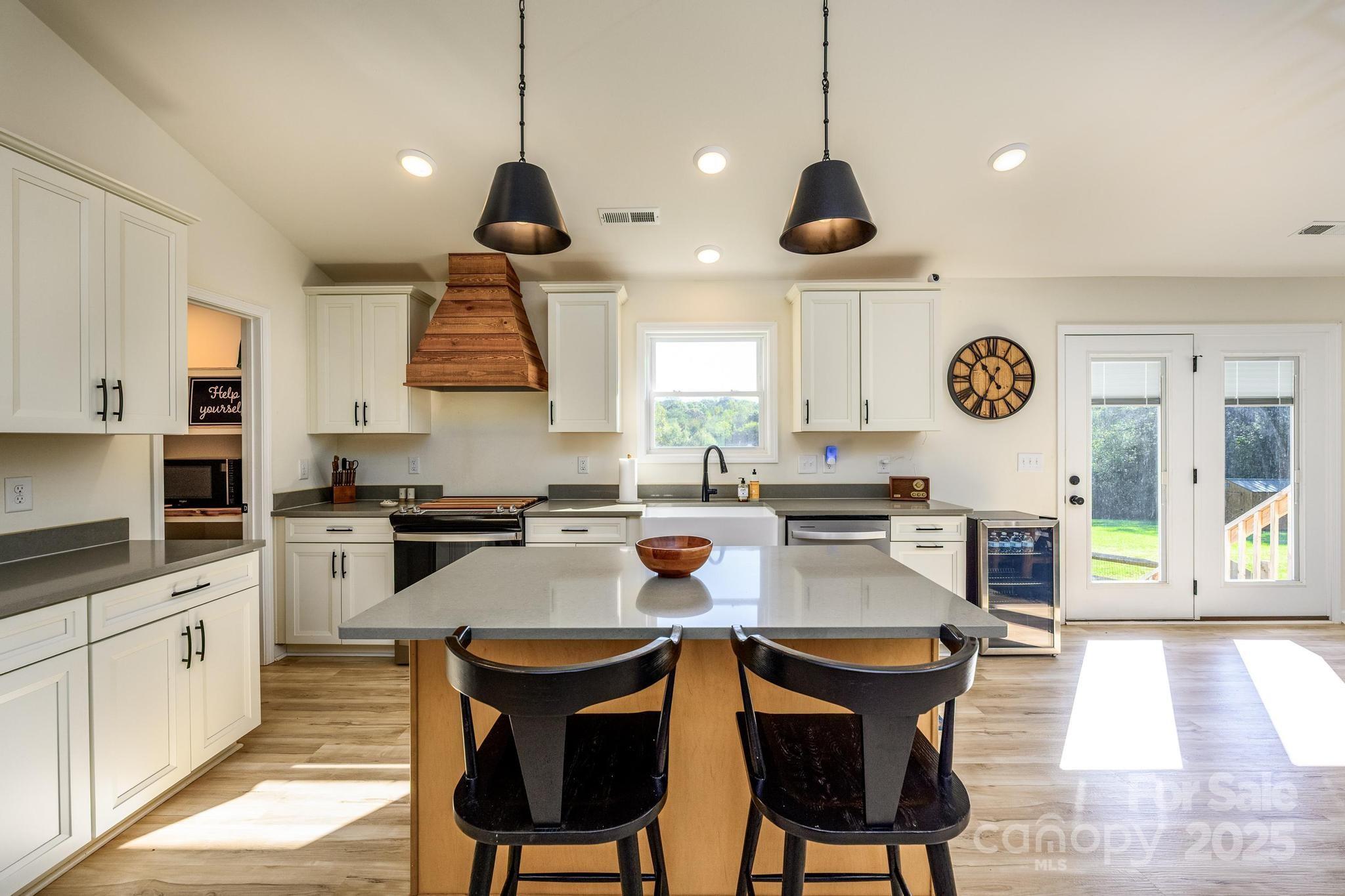 2256 Bolton Road Catawba, NC 28609 - Photo 13 of 48 a kitchen with stainless steel appliances granite countertop a stove a sink a oven a dining table and chairs with wooden floor