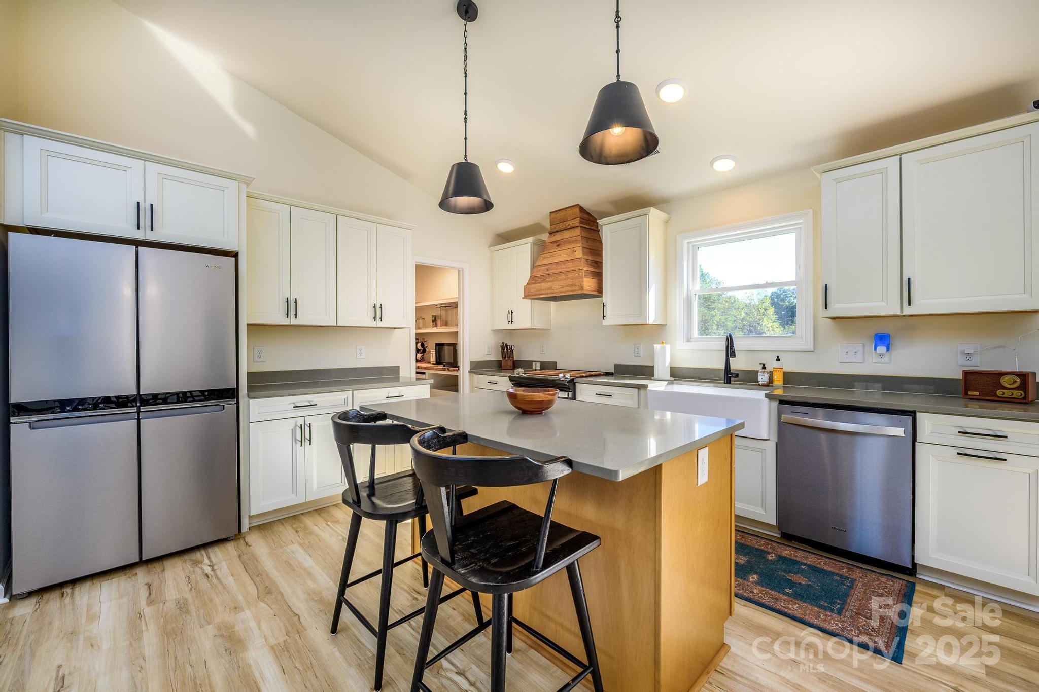 2256 Bolton Road Catawba, NC 28609 - Photo 19 of 48 a kitchen with stainless steel appliances granite countertop a sink a stove a refrigerator and island with wooden floor