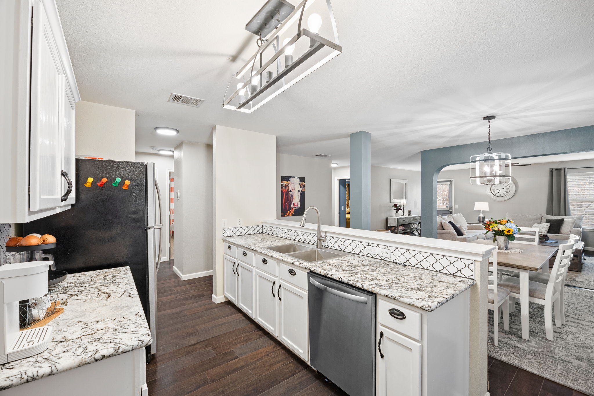 304 Old Peak Road Georgetown, TX 78626 - Photo 39 of 40 Kitchen with a peninsula, white cabinets, dishwasher, and open floor plan