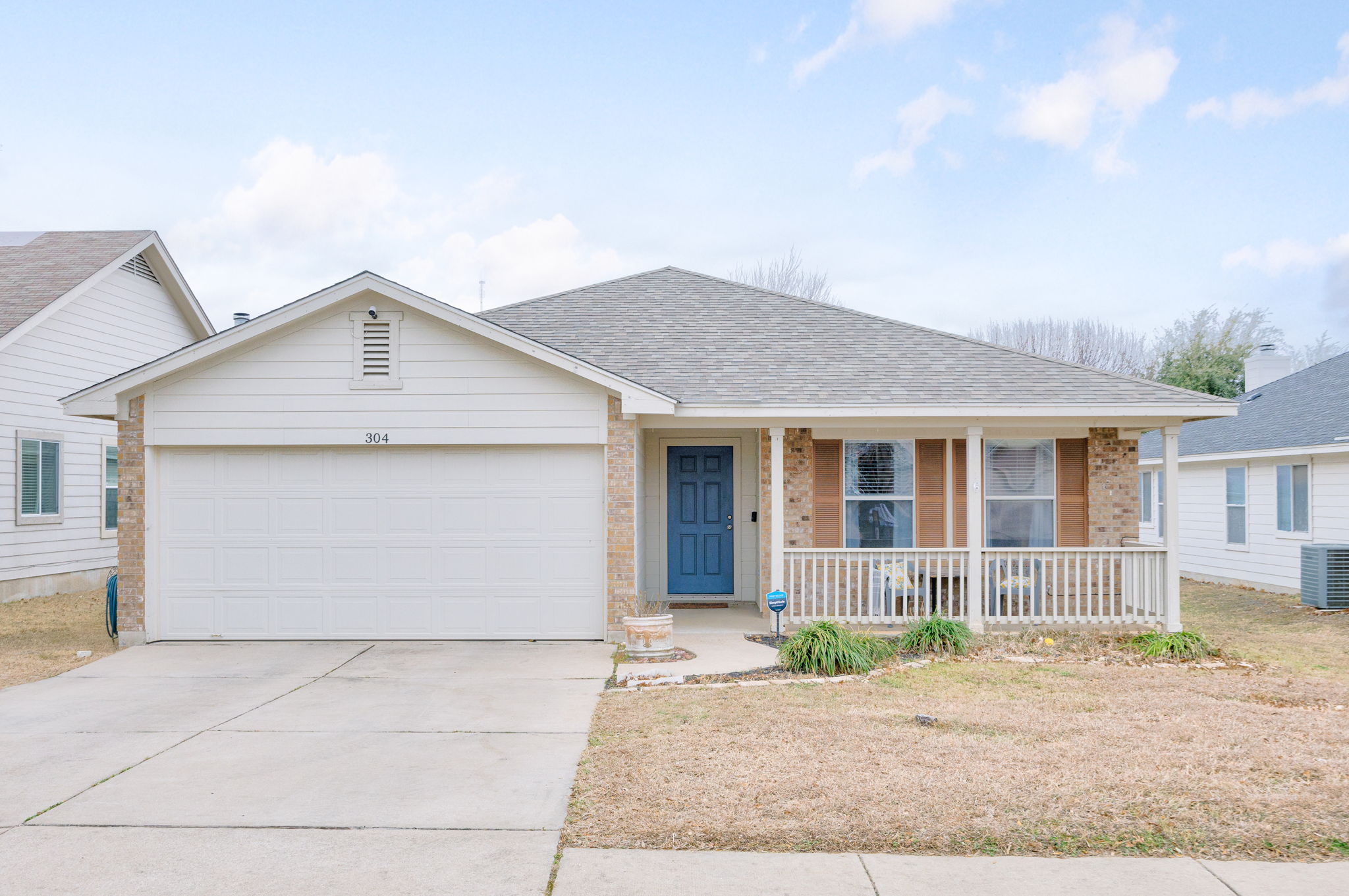 304 Old Peak Road Georgetown, TX 78626 - Photo 2 of 40 Ranch-style house featuring a porch, a shingled roof, brick siding, driveway, and a garage