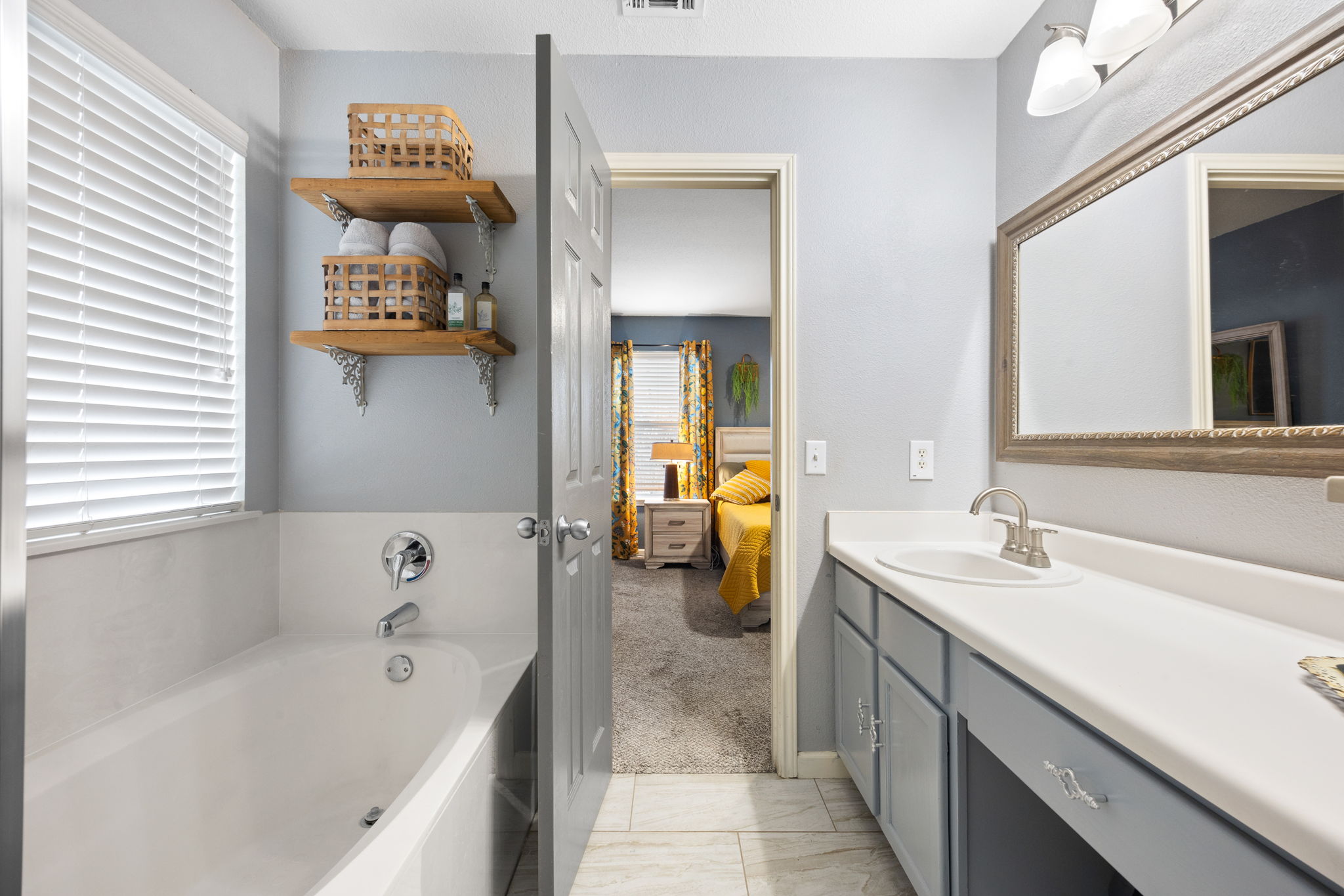 304 Old Peak Road Georgetown, TX 78626 - Photo 19 of 40 Ensuite bathroom with vanity, a garden tub, and light carpet