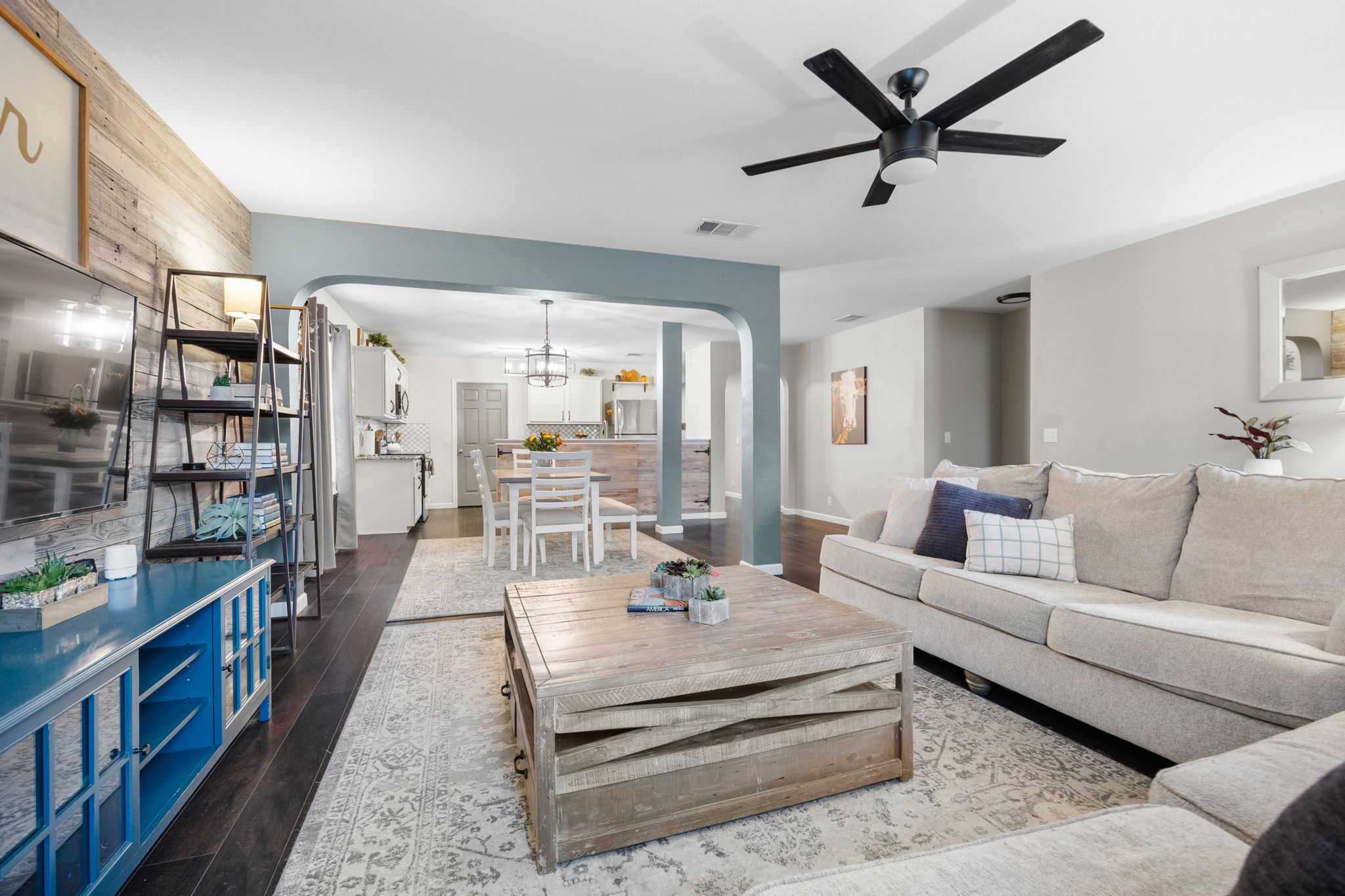 304 Old Peak Road Georgetown, TX 78626 - Photo 7 of 40 Living area with arched walkways, dark wood finished floors, ceiling fan, and a chandelier