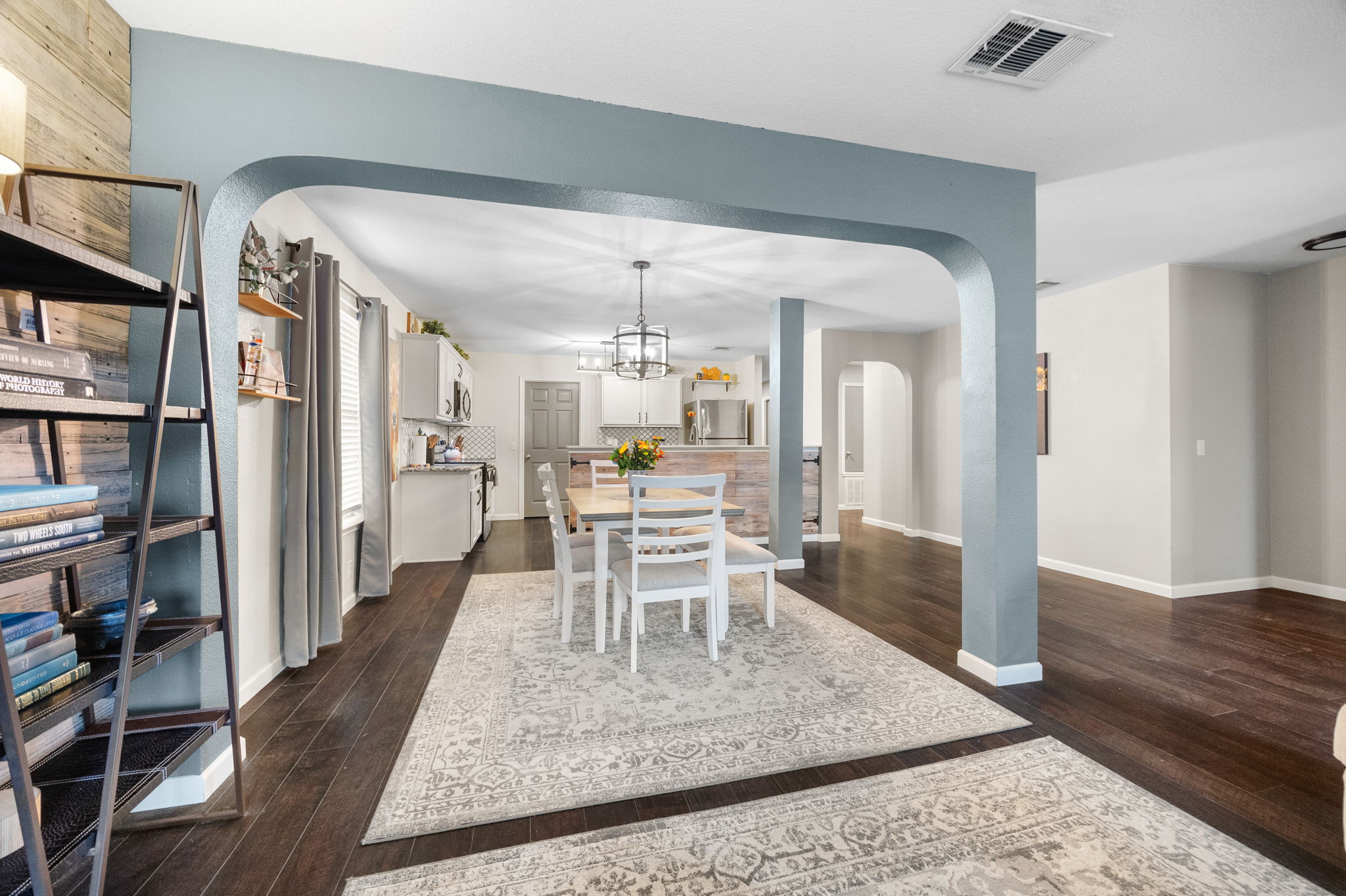 304 Old Peak Road Georgetown, TX 78626 - Photo 9 of 40 Dining area with arched walkways, dark wood finished floors, and a chandelier