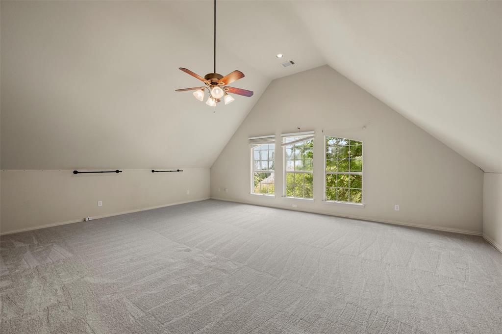 5607 Ranger Drive Rockwall, TX 75032 - Photo 34 of 40 Spacious room featuring sloped ceilings, recessed lighting, and light grey patterned carpeting