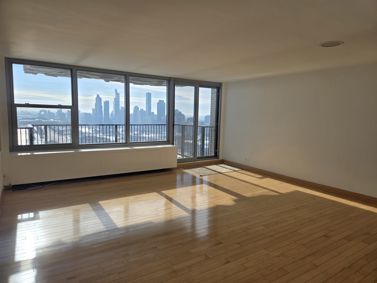 400 East Randolph Street, Unit 3905 Chicago, IL 60601 - Photo 55 of 55 a big room with wooden floor and windows