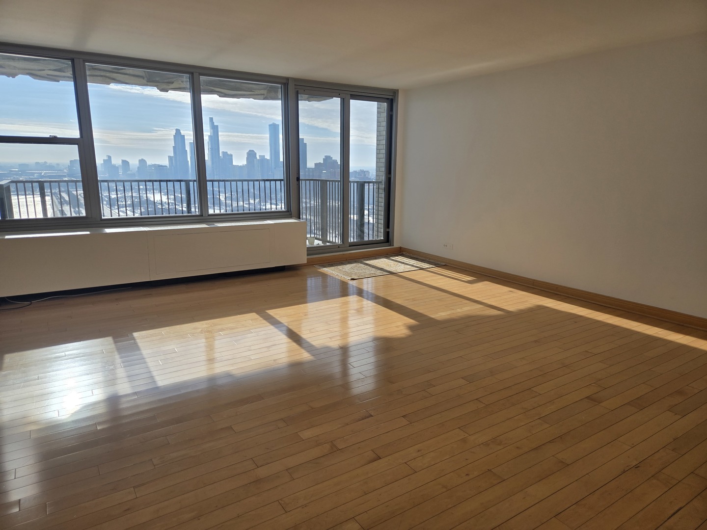 400 East Randolph Street, Unit 3905 Chicago, IL 60601 - Photo 5 of 55 wooden floor in an empty room with a window