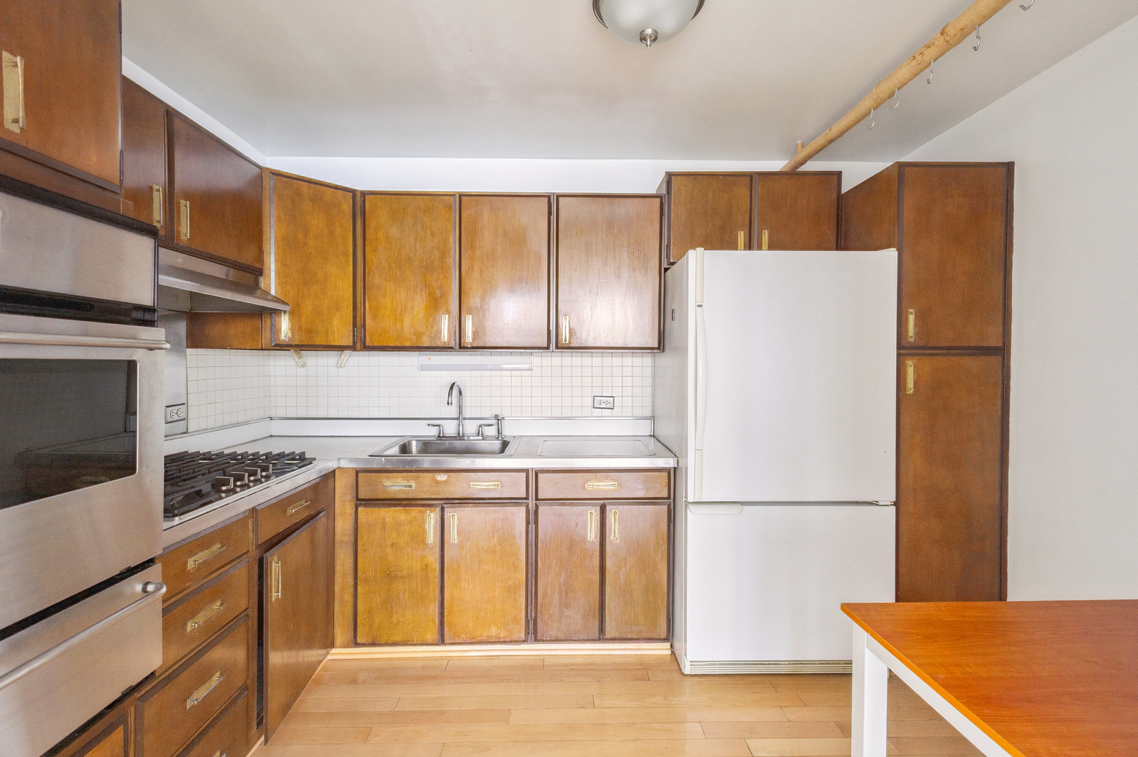 400 East Randolph Street, Unit 3905 Chicago, IL 60601 - Photo 6 of 55 a kitchen with a refrigerator a stove a sink dishwasher and cabinets with wooden floor
