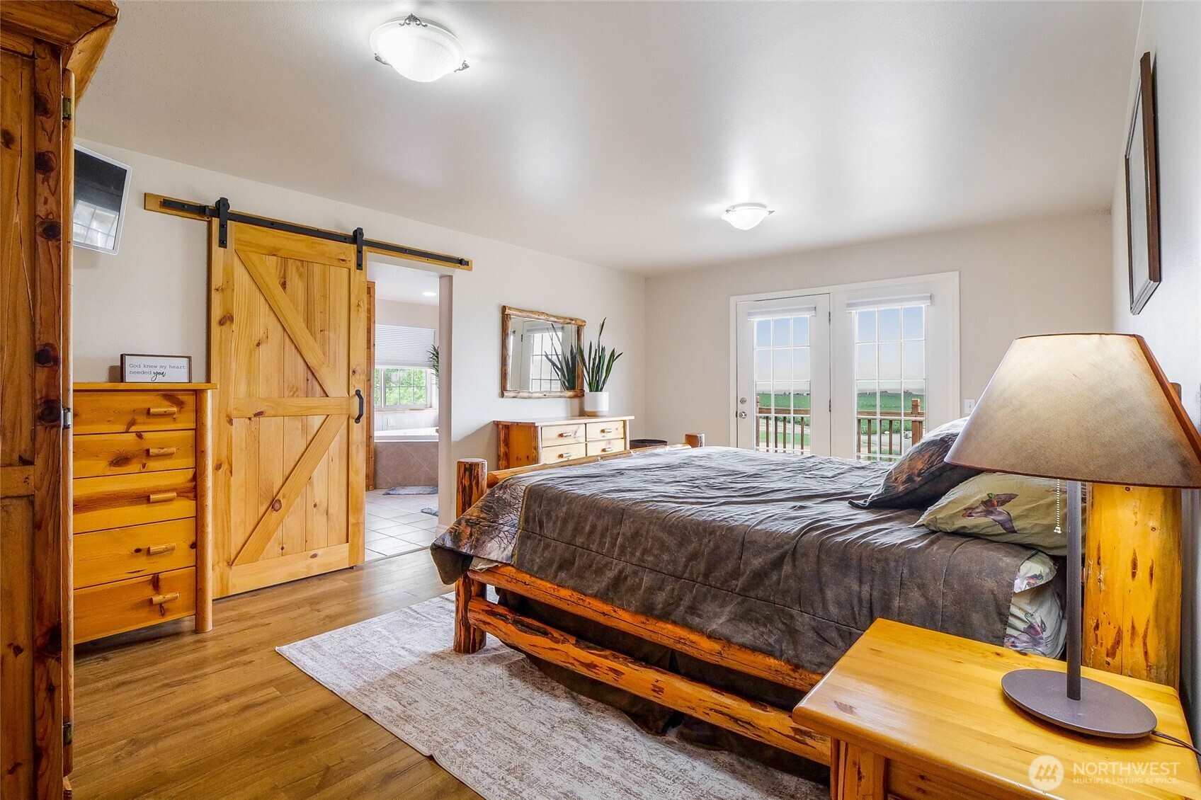 201 Vanderbilt Road Ellensburg, WA 98926 - Photo 23 of 40 a bedroom with a bed and wooden floor