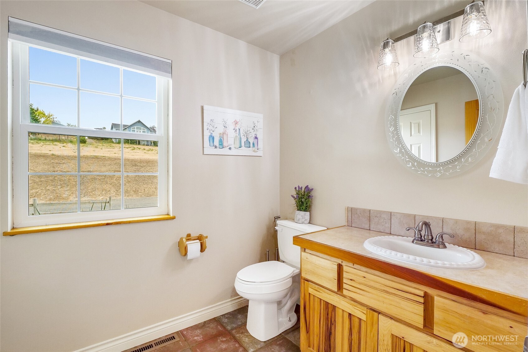201 Vanderbilt Road Ellensburg, WA 98926 - Photo 30 of 40 a bathroom with a granite countertop toilet sink and mirror
