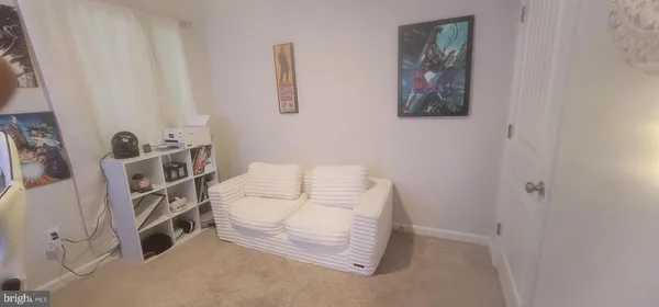 a bed room with a bed window and a chair