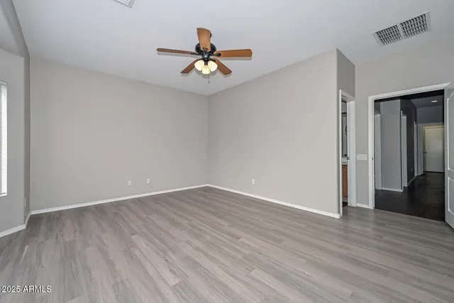 a view of an empty room with wooden floor