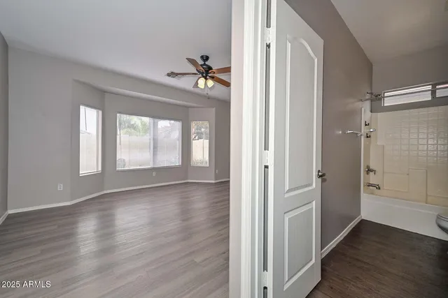 wooden floor in an empty room with a window