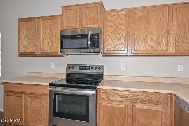 a kitchen with granite countertop white cabinets stainless steel appliances and sink