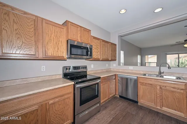 a kitchen with sink a microwave and cabinets