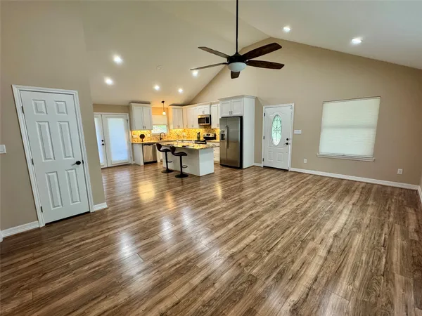 a view of kitchen with cabinets and wooden floor