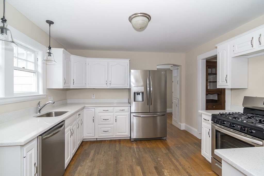 299 Weston Road Wellesley, MA 02482 - Photo 12 of 22 a kitchen with cabinets wooden floor and stainless steel appliances