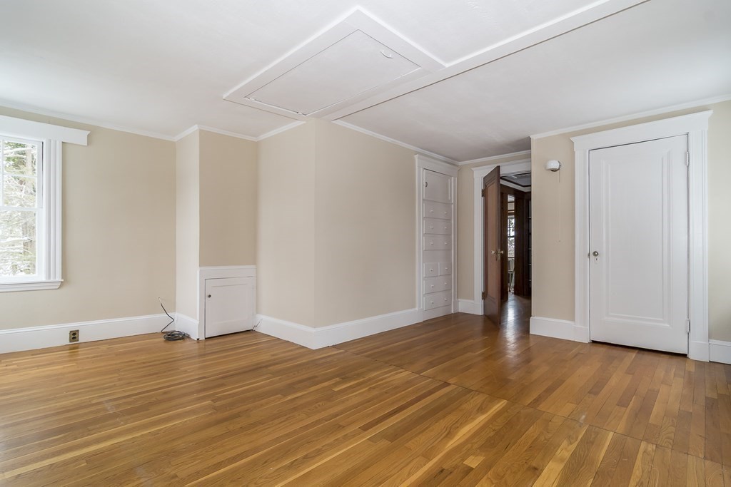 299 Weston Road Wellesley, MA 02482 - Photo 17 of 22 a view of an empty room with wooden floor and a window
